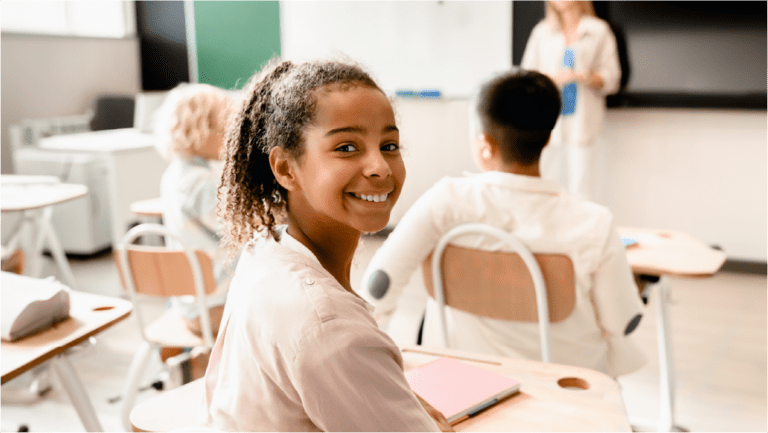 Young girl smiling in classroom