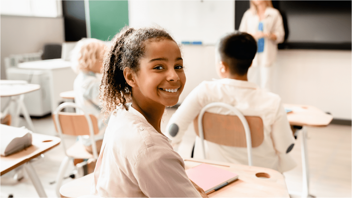 Young girl smiling in classroom